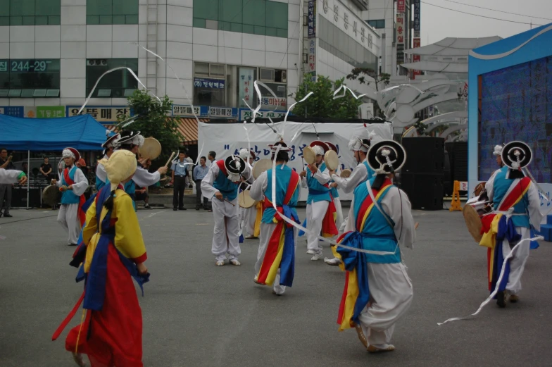 a group of people walking down a street wearing costumes