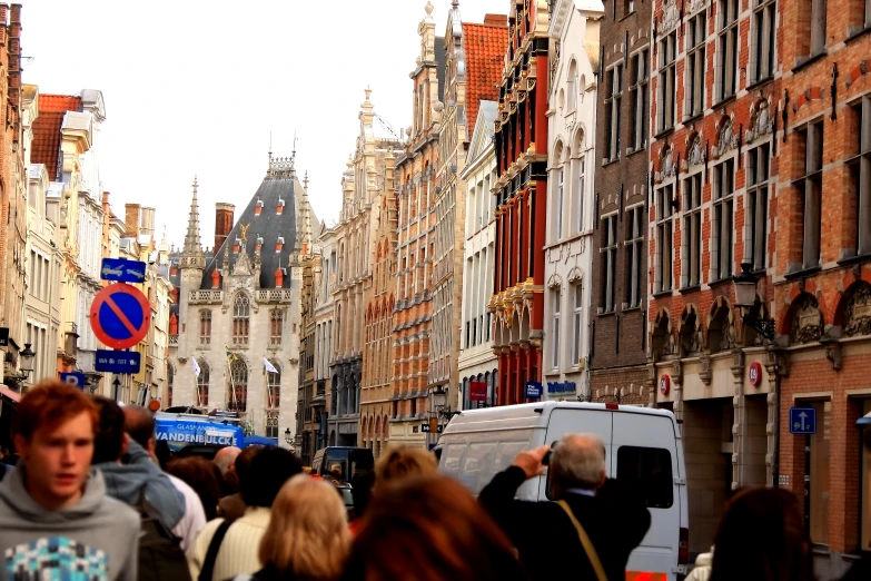 some people walking in the street near many buildings