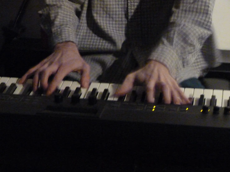 a close up of a person with their hands on an organ