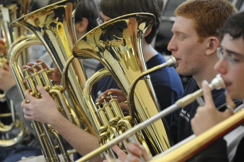 group of young men playing different musical instruments