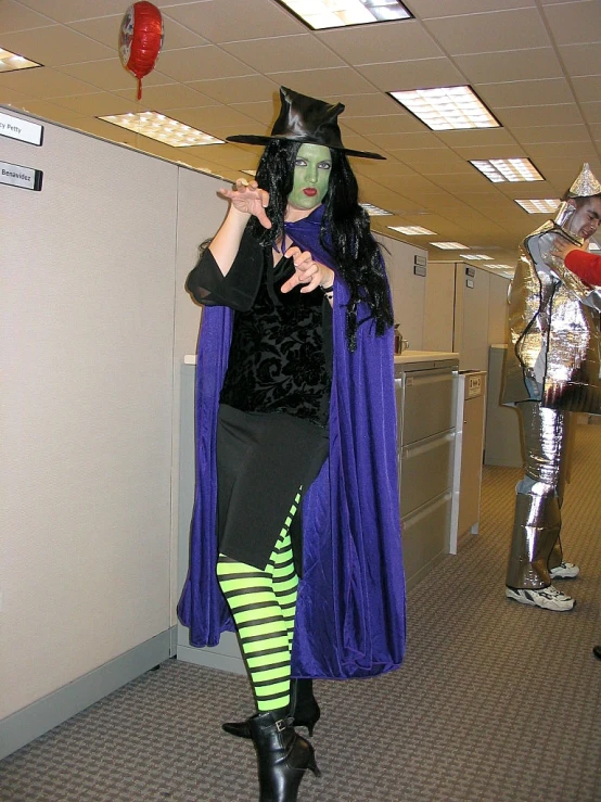 a woman in costume with an evil head and horns