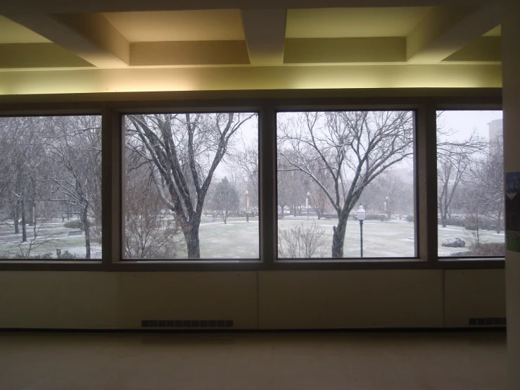 a large window with a view of a snow covered field