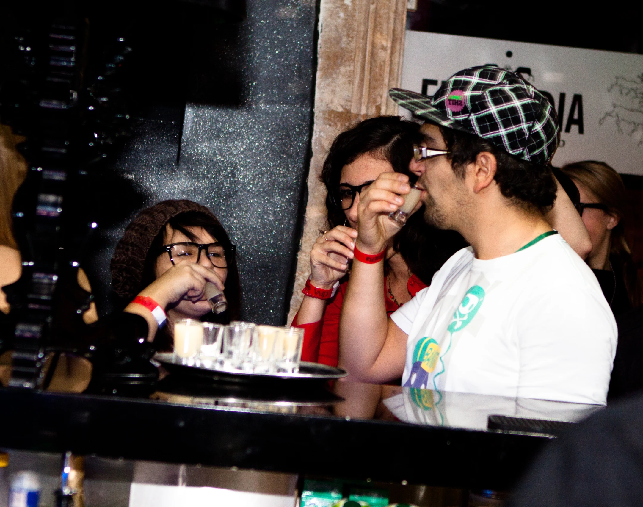 a group of people sitting around a table with plates and drinks