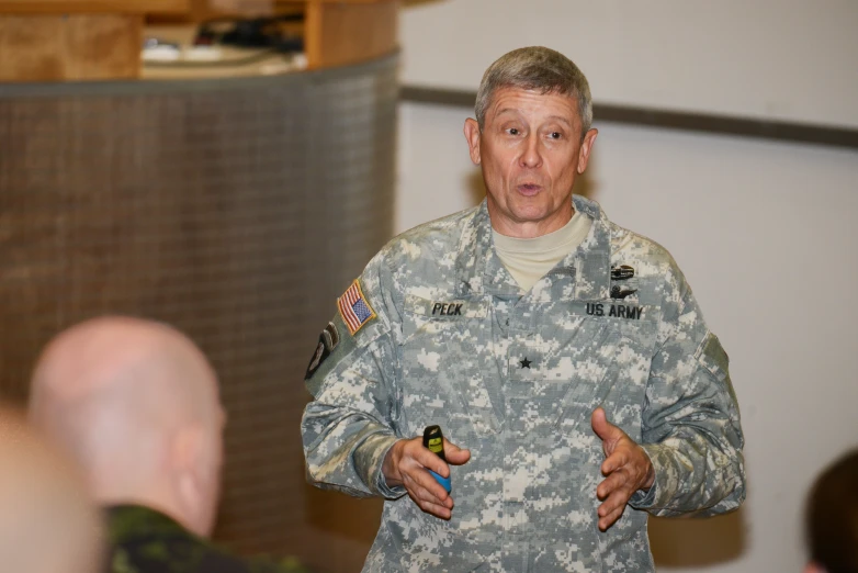 a man in uniform gives a lecture to others