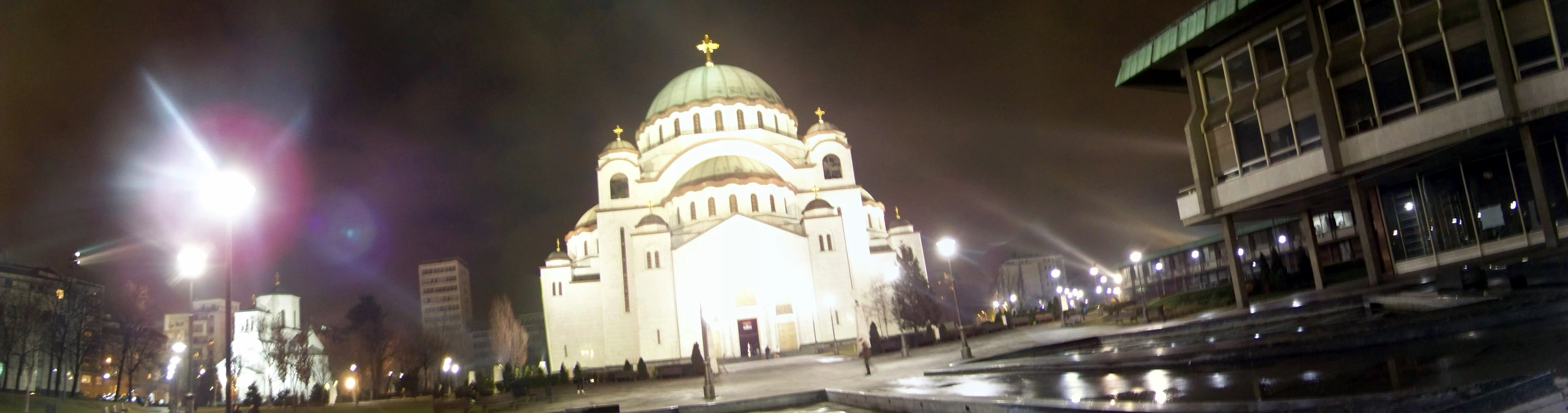 a tall church in a city at night