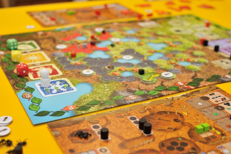 some different colored board games sitting on a yellow table