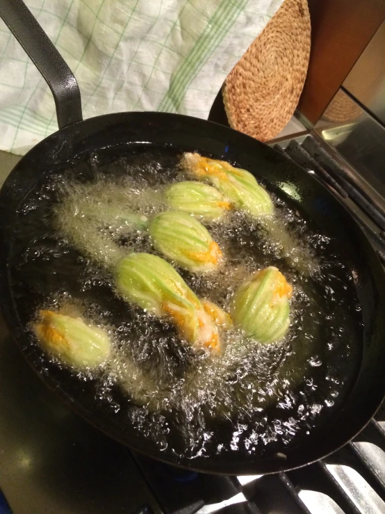 an omelet frying in oil on top of a stove