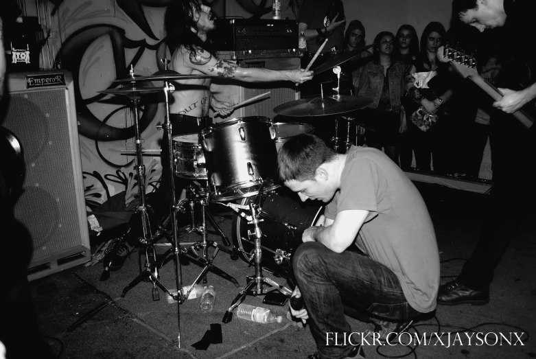 a band performing in front of an audience with instruments