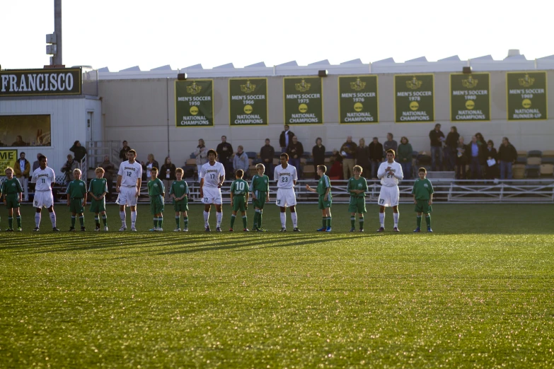 s stand together in uniforms for a soccer game
