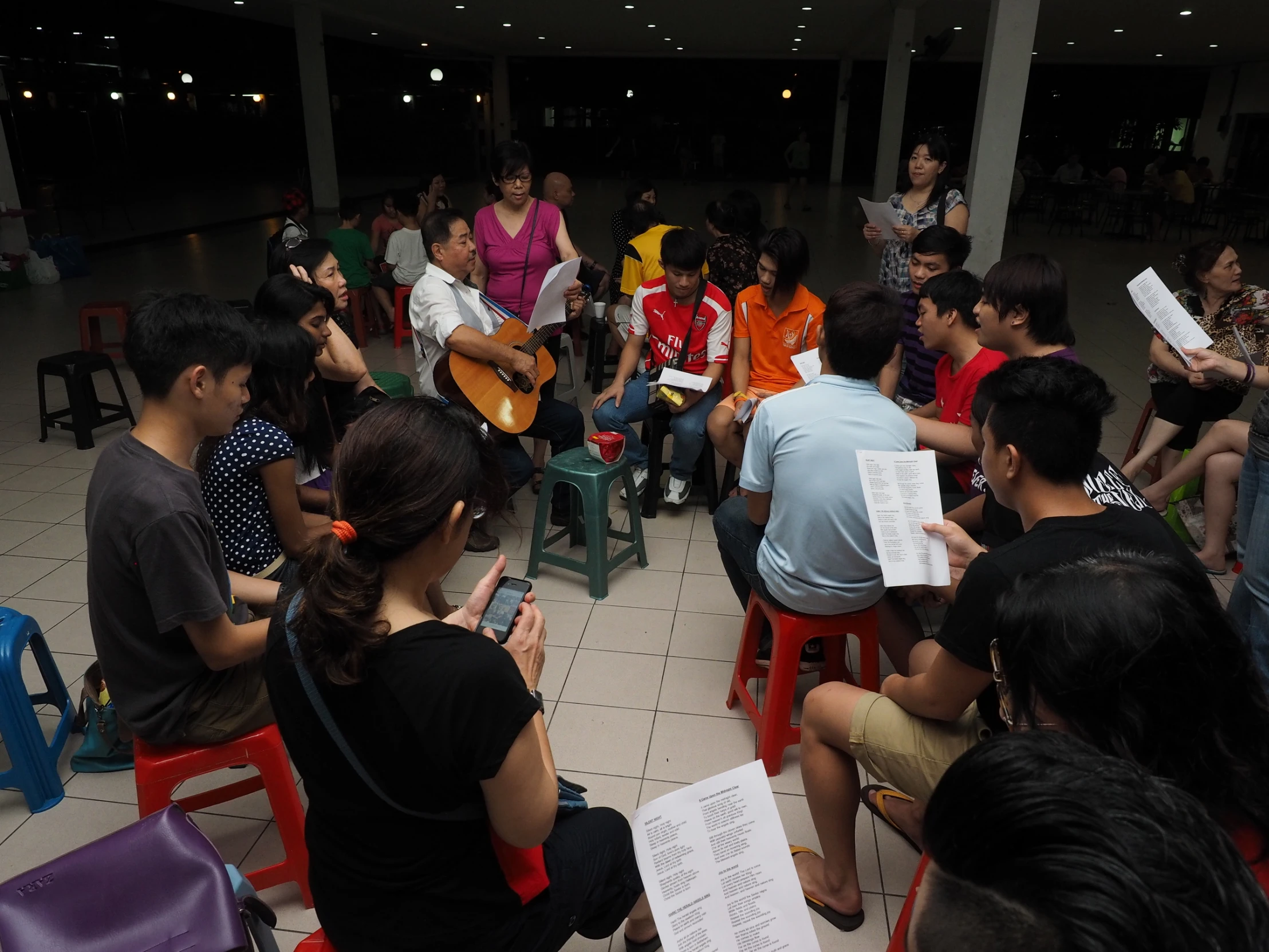 a group of people sitting around playing instruments