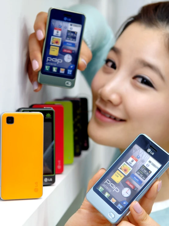 a person holding a phone in front of colorful devices