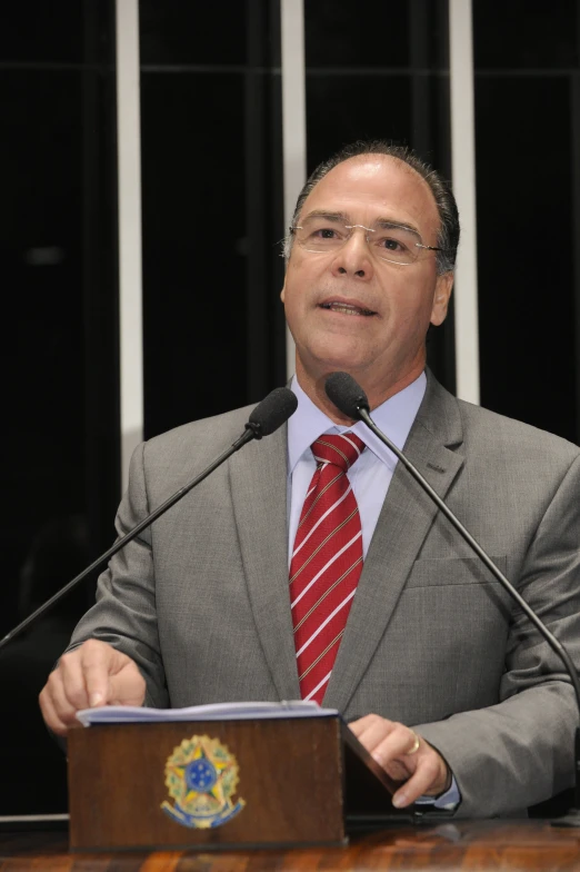 a man at a podium giving a speech to people