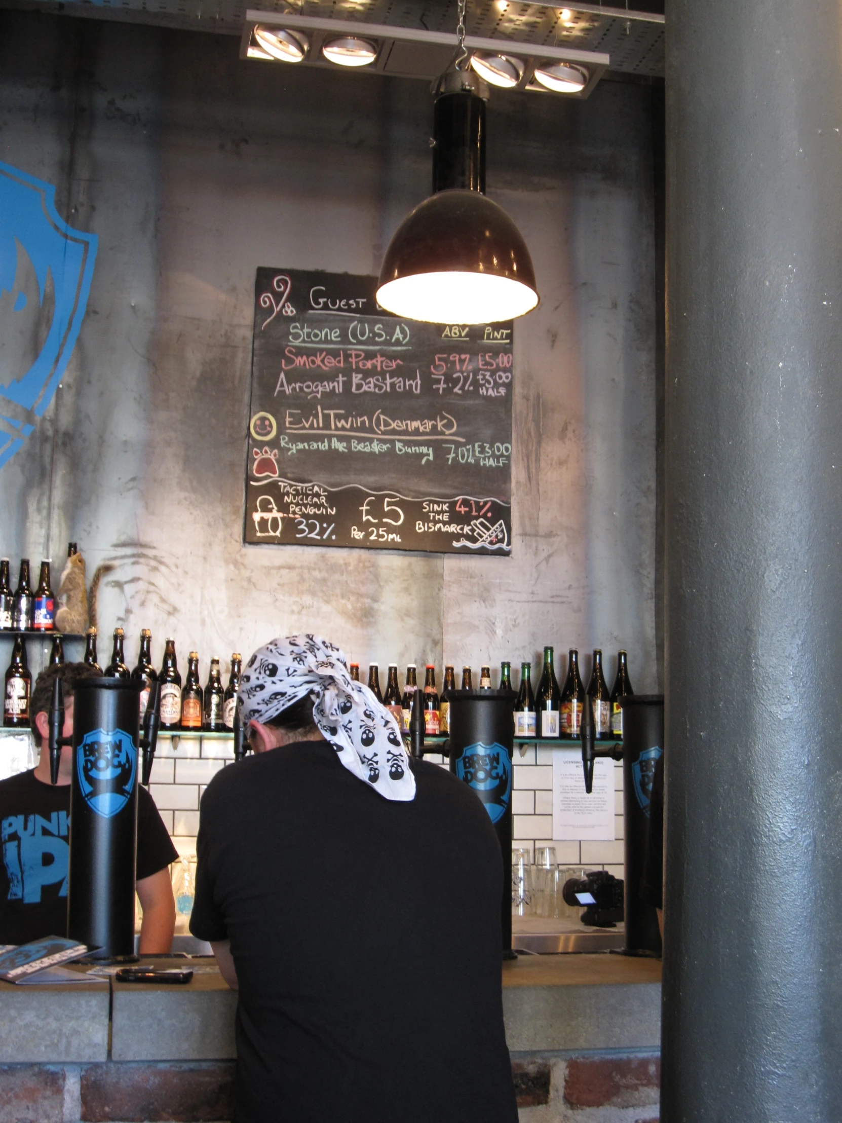 a man standing behind a bar in a restaraunt