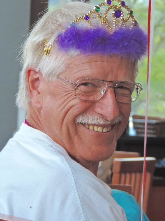 a man with glasses and a purple wig