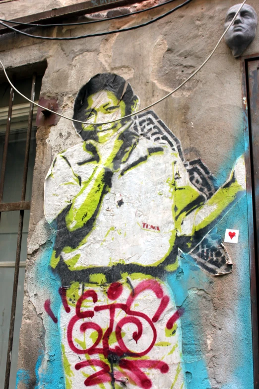 graffiti on the side of a building depicting a male singer