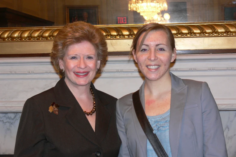 two women standing next to each other posing for a picture