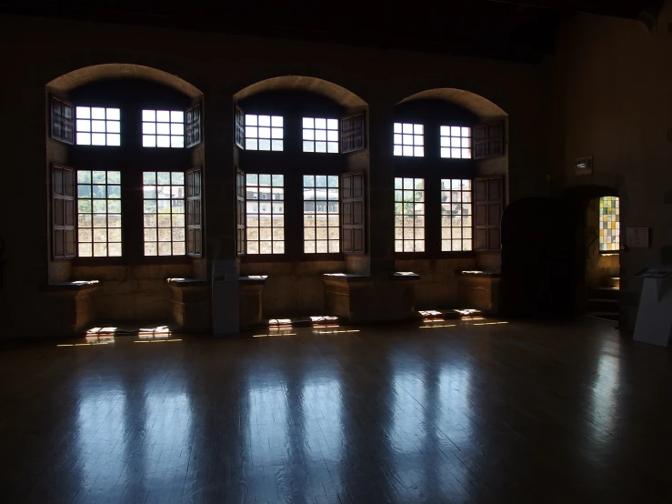 several windows, lights and candles are projected on the floor