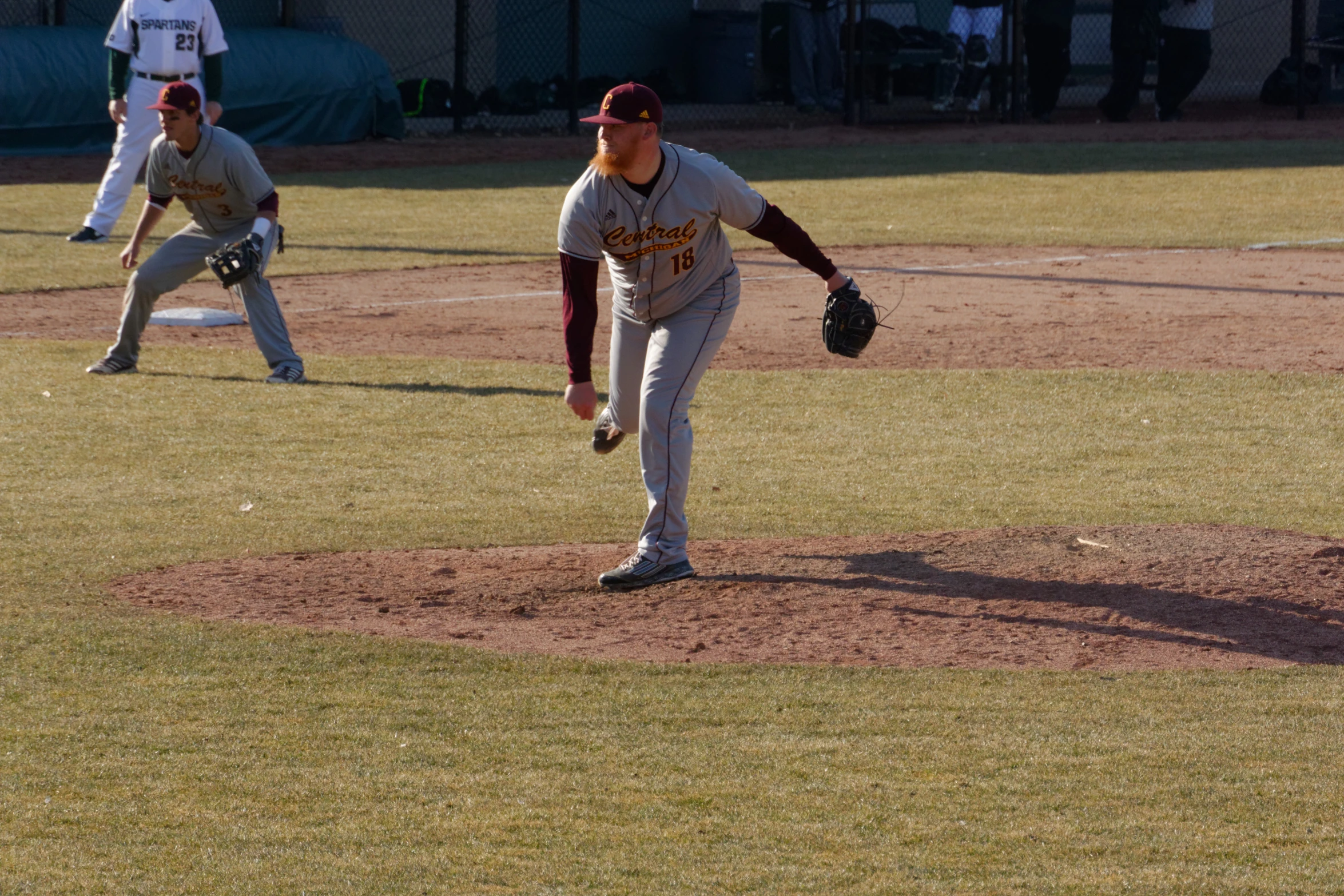 two players from two teams playing baseball on field