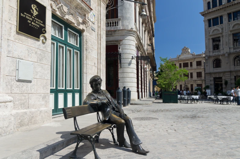 the statue is on the bench near the entrance