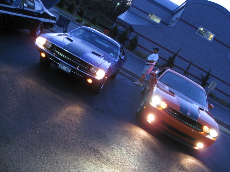 two cars parked beside each other near a street