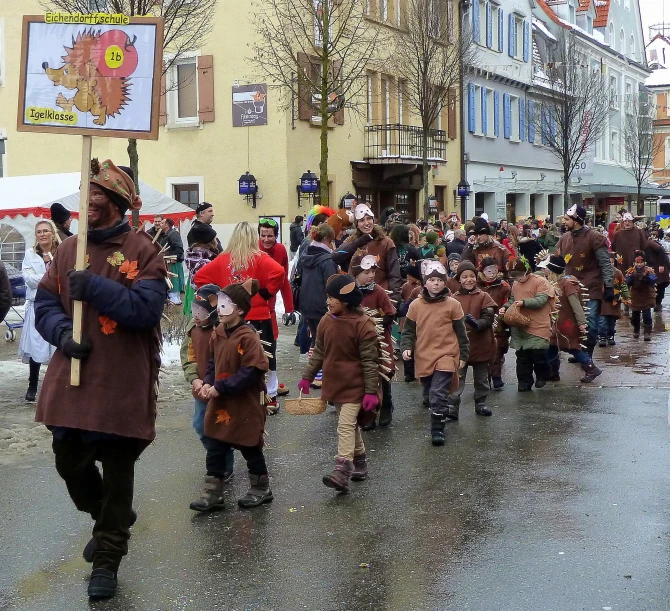 the people are in brown coats on the street