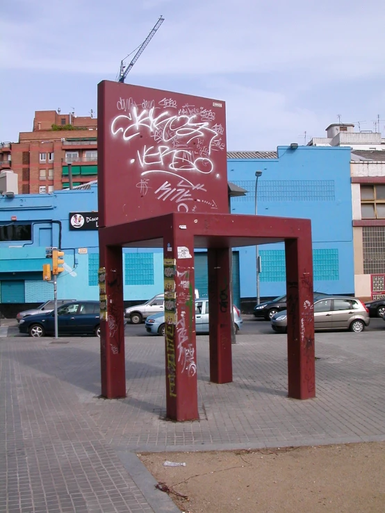 an open red chair in the middle of a city street