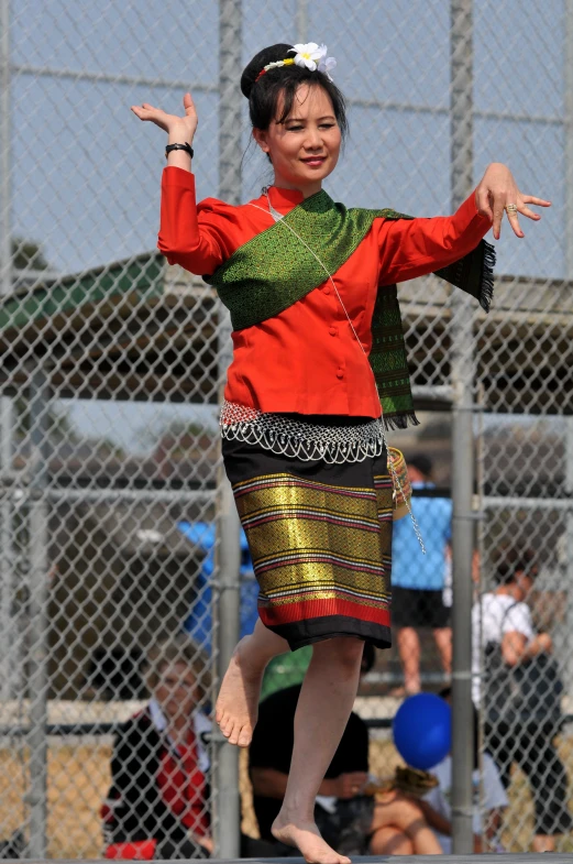 a young woman in oriental attire on a court