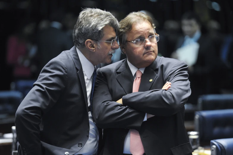 two men in suits looking at each other