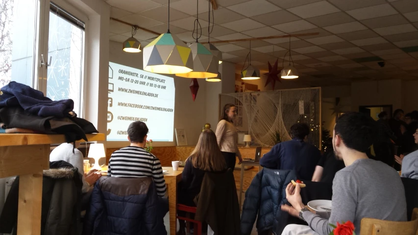 people are seated in front of a table in the office