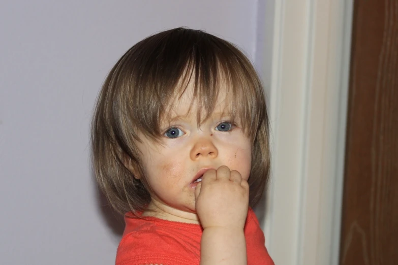 a close up of a child brushing his teeth