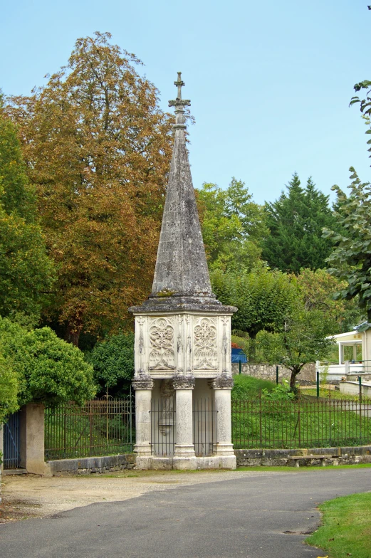 a white and black clock tower sitting on the side of a road