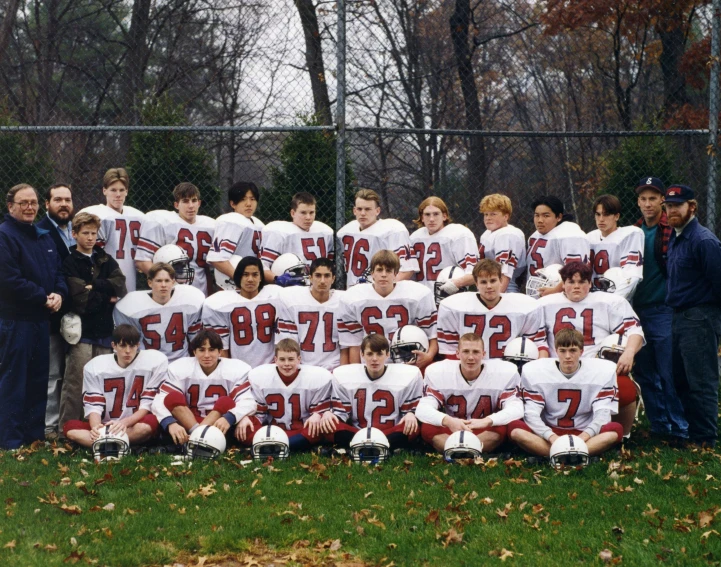 a group of people wearing white and red jerseys