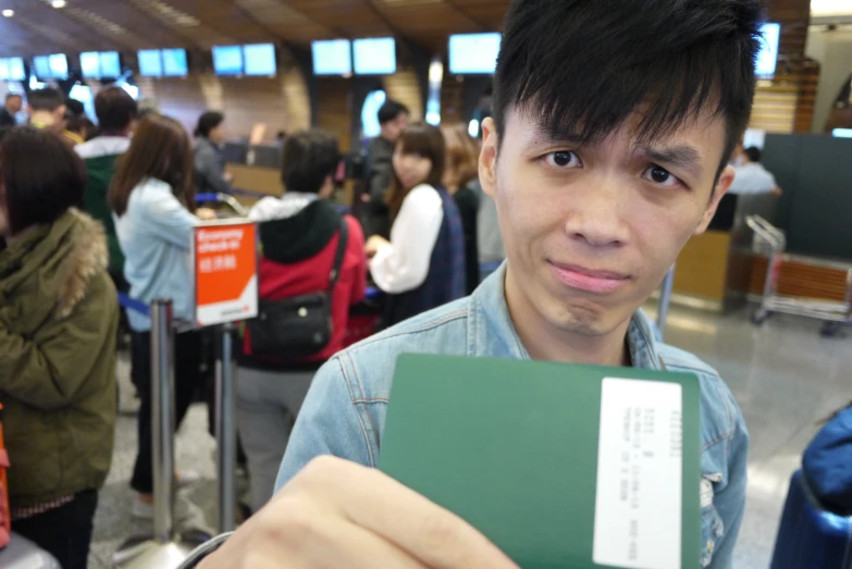 a man holding a passport in front of people