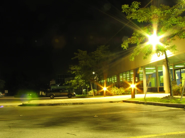 the car is parked at night time near the store