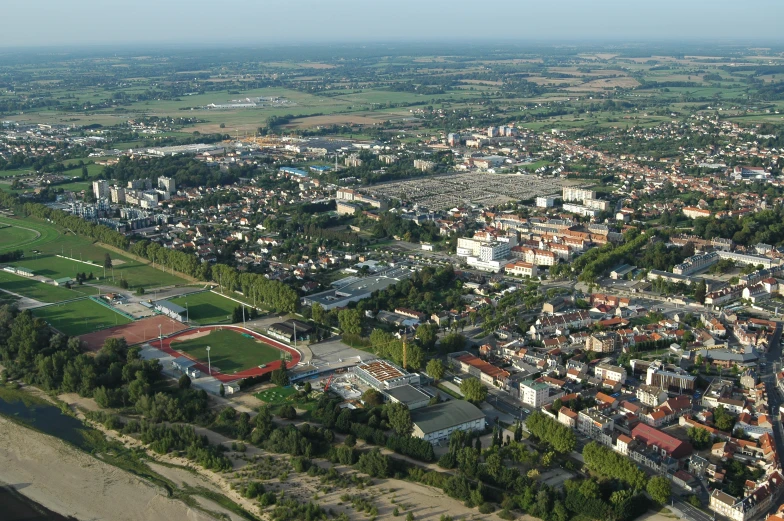 aerial po of large city with lots of trees