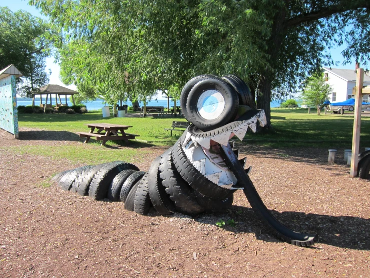 the tire dragon sculpture is on display in the park