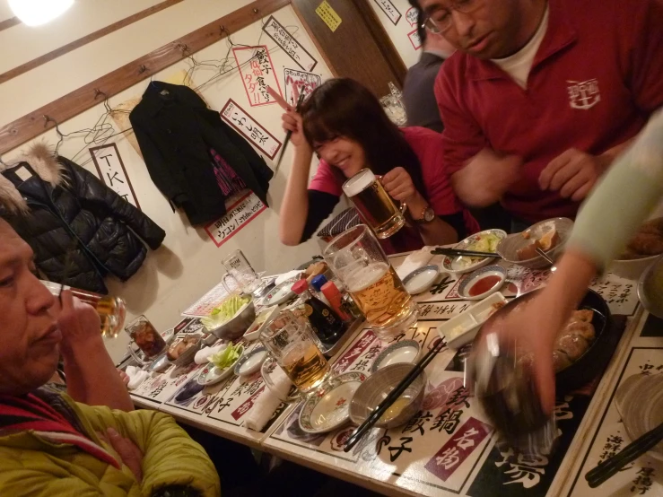 people sitting at a table with food on it