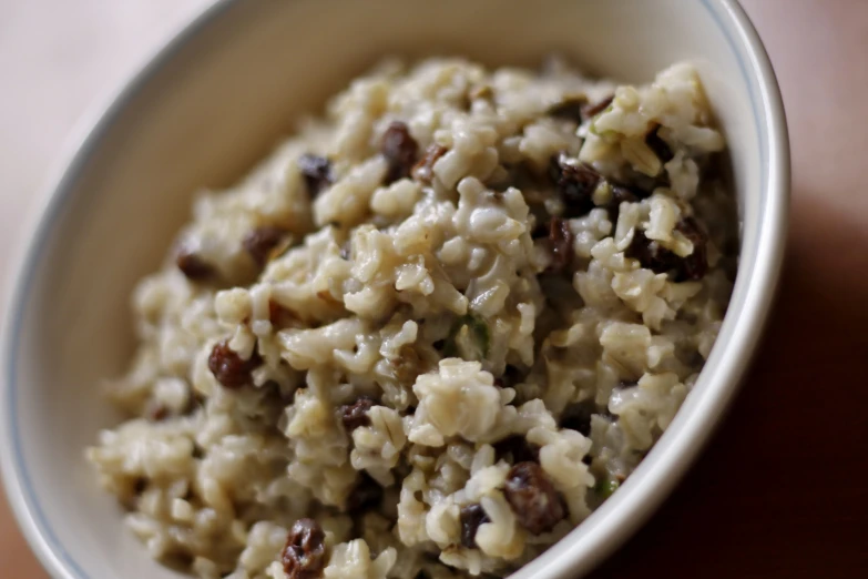 a bowl of rice with raisins on top