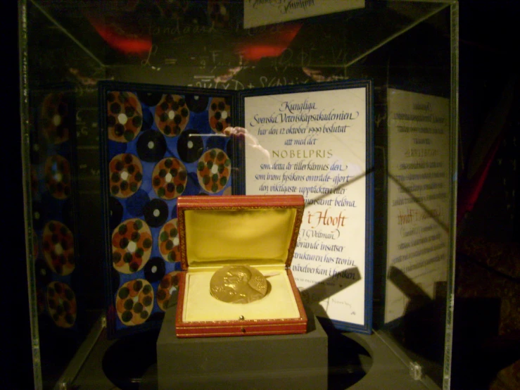 a display case with a single piece of gold coins in it