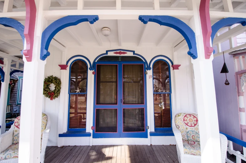 a porch covered in blue and white furniture