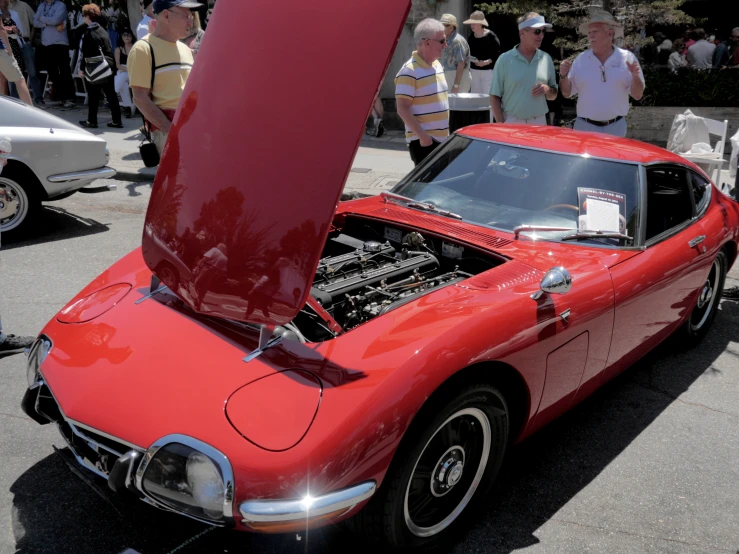 a red car that is sitting in the street