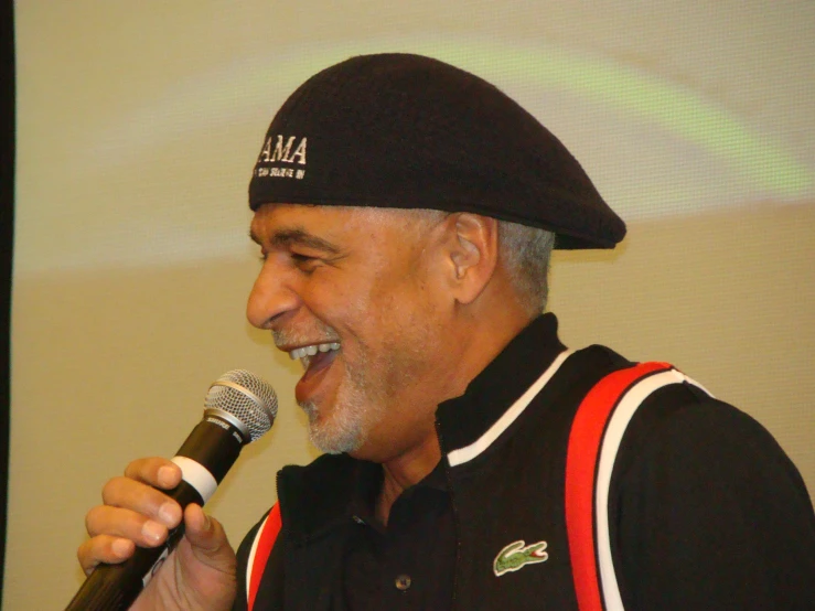a man in black jacket holding a microphone