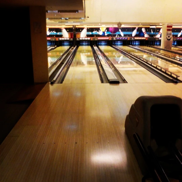 two lanes of bowling, one of which is still intact from all the pins