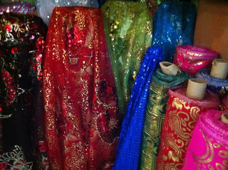 a number of colorful sequined cloths sitting on top of a table