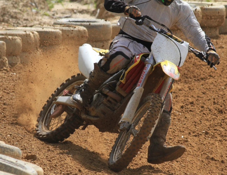 a man rides a dirt bike down the track