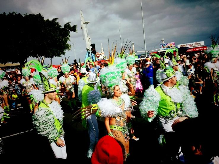 a group of people wearing carnival outfits standing together