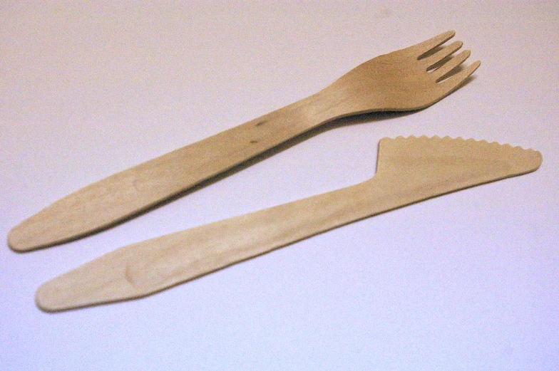 two wooden utensils laying on the floor