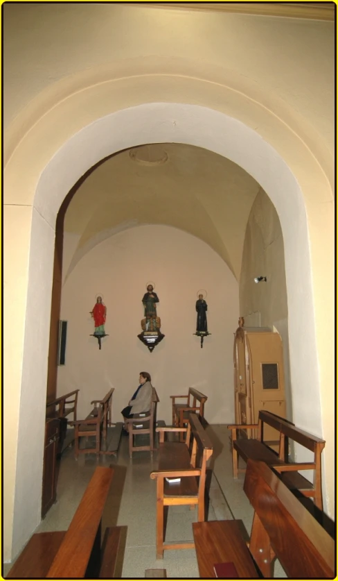 an empty church with some wooden benches and wood tables