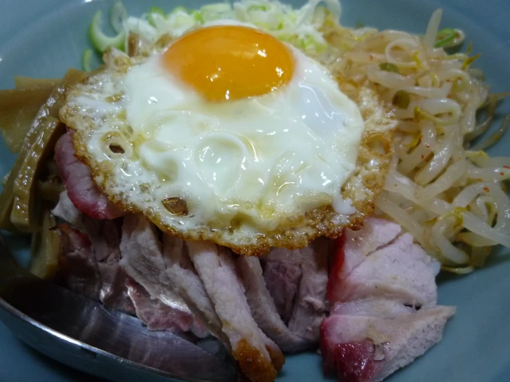 plate with food, eggs and noodles on it