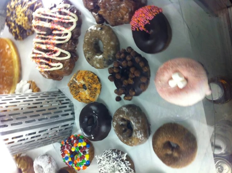 a display case has many different kinds of doughnuts